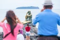 Tourists taking photos the Mermaid golden statue symbol of the S